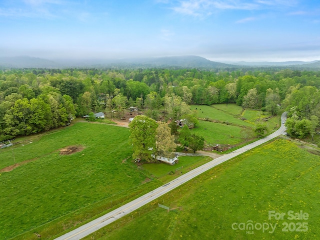 bird's eye view featuring a wooded view