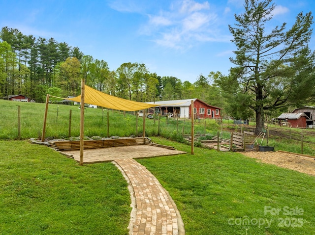 view of yard featuring a vegetable garden and fence