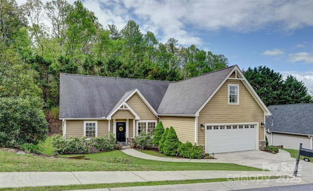 view of front facade featuring concrete driveway, an attached garage, a shingled roof, and a front yard