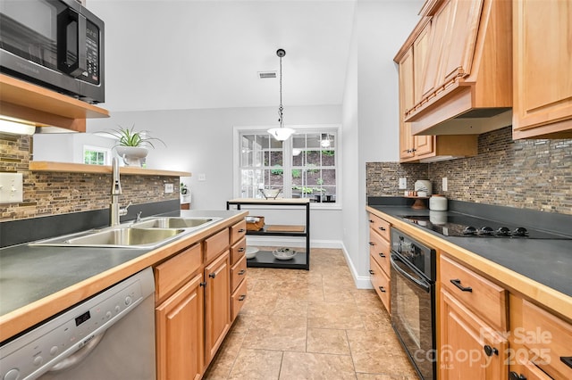 kitchen with a sink, premium range hood, tasteful backsplash, visible vents, and black appliances