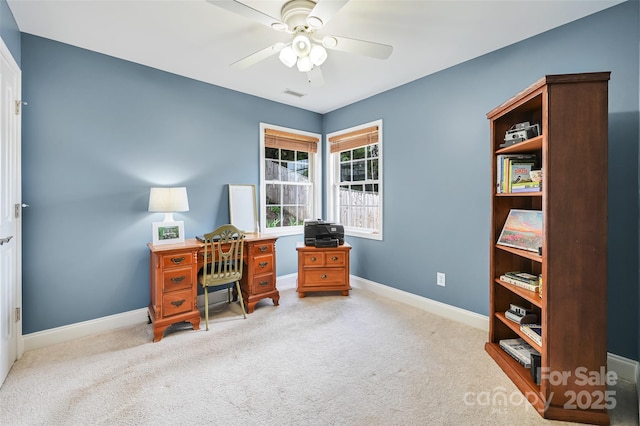 office with light colored carpet, ceiling fan, visible vents, and baseboards