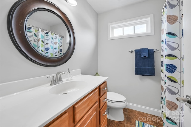 bathroom featuring toilet, baseboards, curtained shower, and vanity