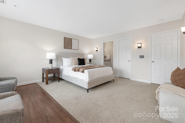 bedroom featuring wood finished floors and baseboards