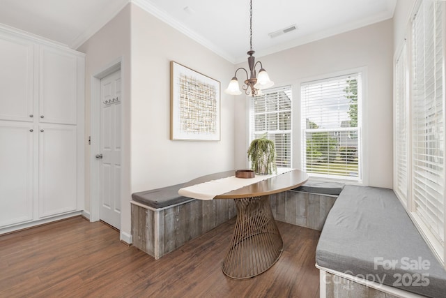 dining space featuring ornamental molding, wood finished floors, breakfast area, and a chandelier