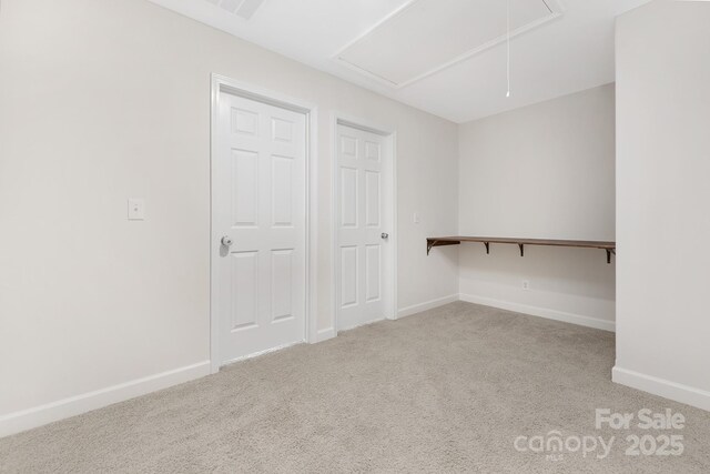 interior space featuring attic access and carpet floors