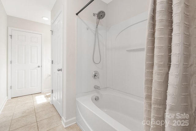 bathroom with shower / bath combination with curtain, tile patterned floors, and baseboards