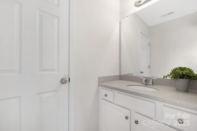 bathroom featuring visible vents and vanity