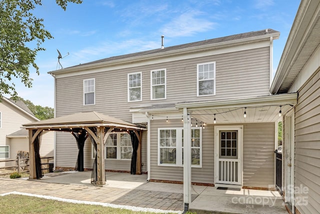 back of house with a gazebo and a patio area
