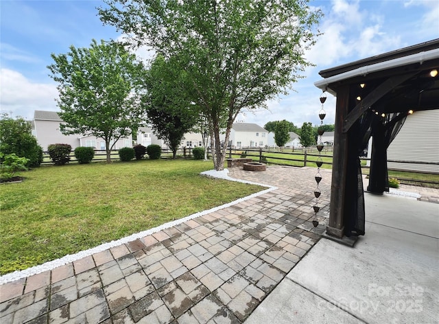 view of patio / terrace with fence and an outdoor fire pit
