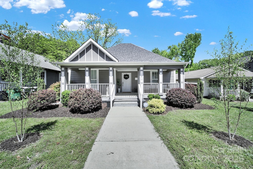 1517 Parkwood Ave, Charlotte, NC 28205 - view of front of home featuring a porch, a front lawn, and a shingled roof
