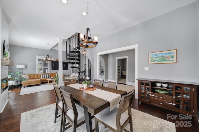 dining room with recessed lighting, stairs, hardwood / wood-style floors, and a chandelier