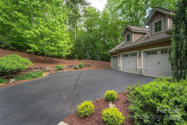 168 Chattooga Run, Hendersonville, NC 28739 - view of side of property featuring asphalt driveway and stone siding