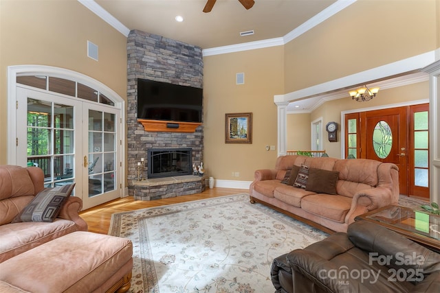 168 Chattooga Run, Hendersonville, NC 28739 - living room featuring a towering ceiling, a ceiling fan, crown molding, a chandelier, and wood finished floors