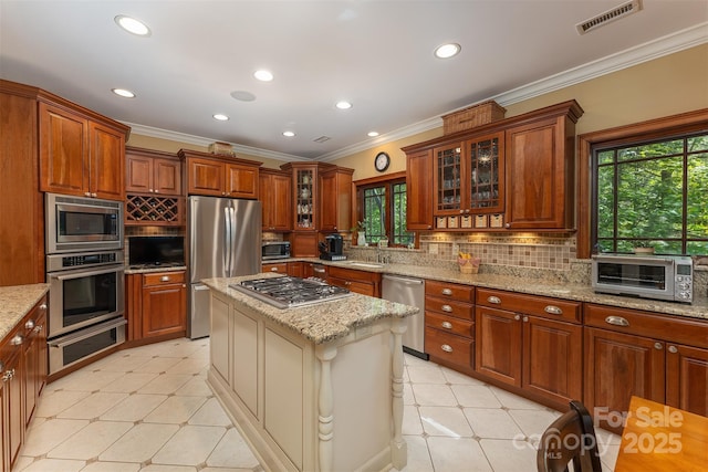 168 Chattooga Run, Hendersonville, NC 28739 - kitchen with appliances with stainless steel finishes, a warming drawer, a sink, glass insert cabinets, and ornamental molding