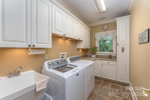 168 Chattooga Run, Hendersonville, NC 28739 - laundry area with independent washer and dryer, cabinet space, ornamental molding, stone finish floors, and baseboards