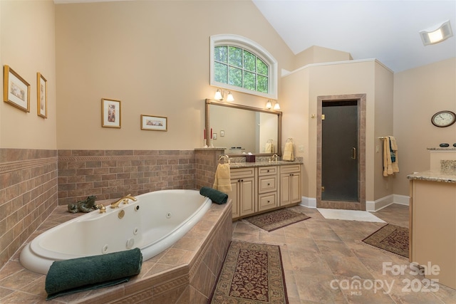 168 Chattooga Run, Hendersonville, NC 28739 - bathroom featuring a shower stall, a whirlpool tub, vanity, high vaulted ceiling, and baseboards