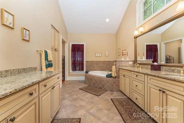 168 Chattooga Run, Hendersonville, NC 28739 - bathroom with vaulted ceiling, a garden tub, double vanity, and recessed lighting