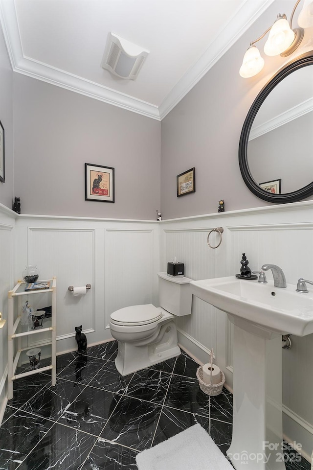 168 Chattooga Run, Hendersonville, NC 28739 - bathroom featuring a decorative wall, a wainscoted wall, crown molding, toilet, and marble finish floors