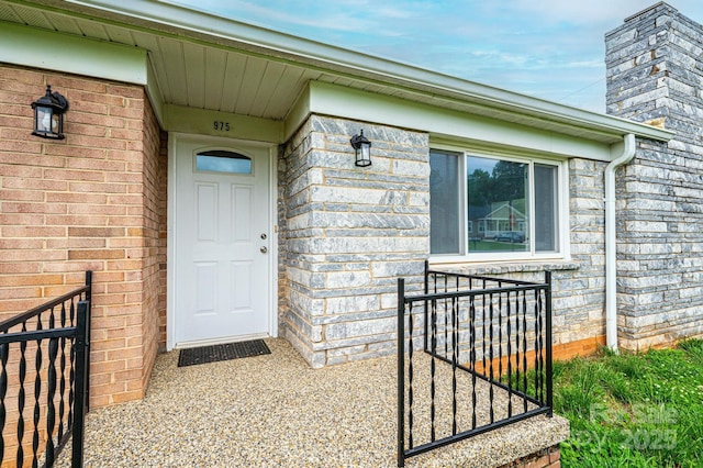 doorway to property featuring a chimney
