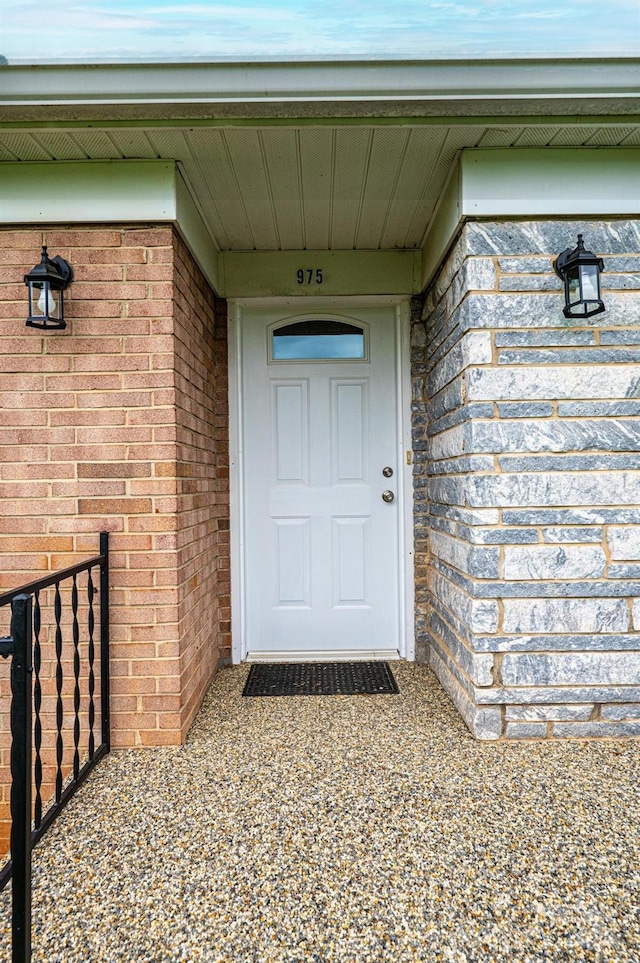 doorway to property with brick siding