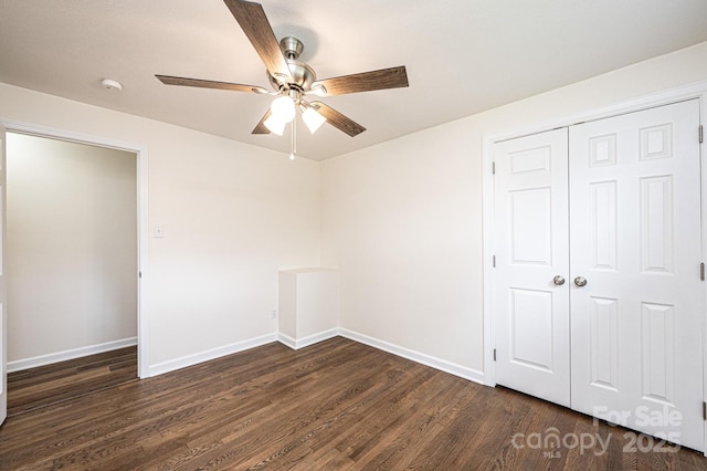 unfurnished bedroom with baseboards, ceiling fan, a closet, and dark wood-style floors