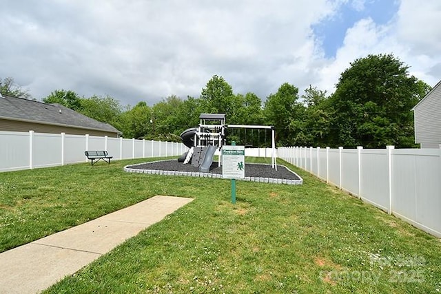 view of yard featuring a playground and fence