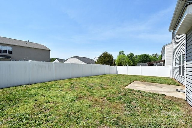 view of yard featuring a patio area and a fenced backyard