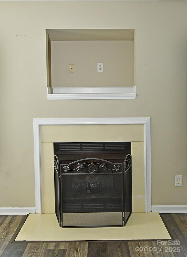 details featuring wood finished floors and baseboards