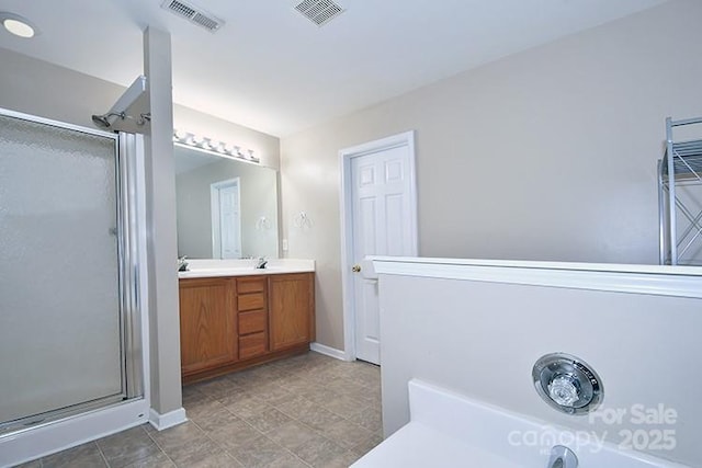 full bath with visible vents, a shower stall, and baseboards