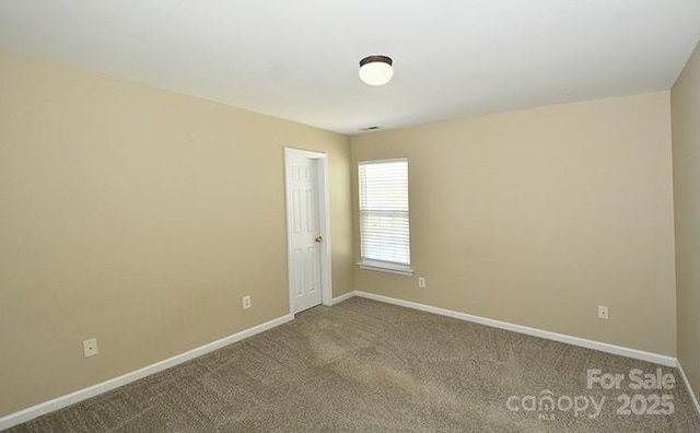 carpeted empty room with baseboards