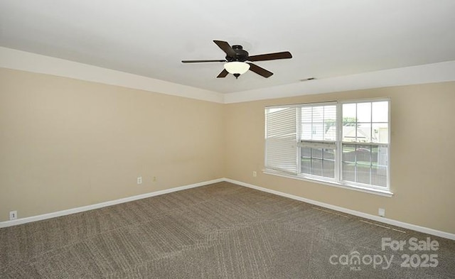 spare room featuring baseboards, a ceiling fan, visible vents, and carpet