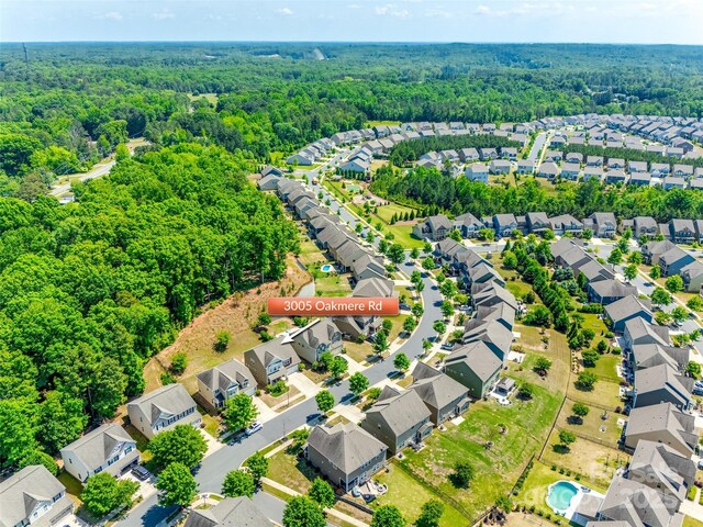 aerial view featuring a view of trees and a residential view
