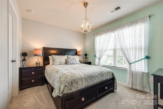 bedroom featuring baseboards, light carpet, a notable chandelier, and visible vents