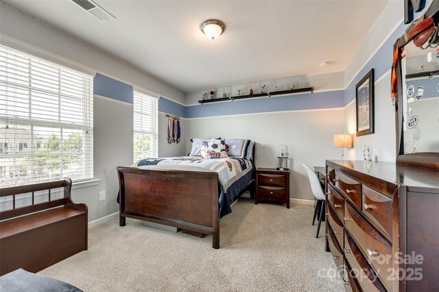 carpeted bedroom featuring baseboards and visible vents