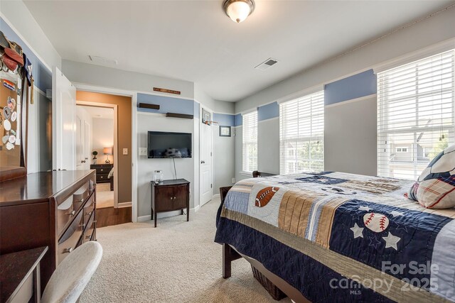 bedroom featuring baseboards, visible vents, and carpet