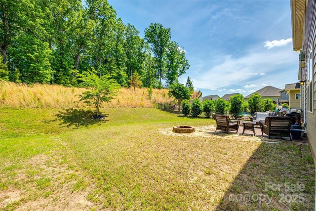 view of yard with a patio area and an outdoor living space with a fire pit