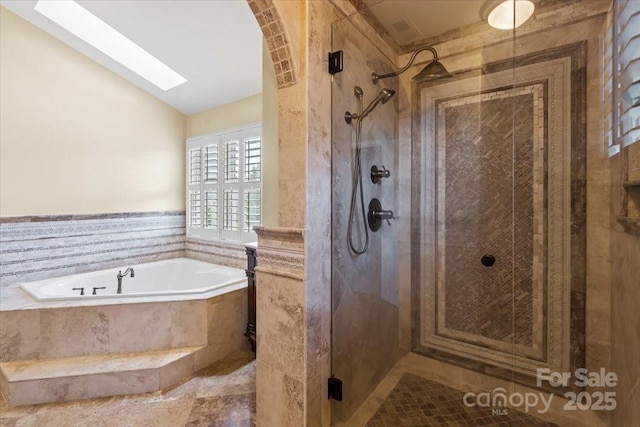 full bathroom with a stall shower, lofted ceiling, a garden tub, and a skylight