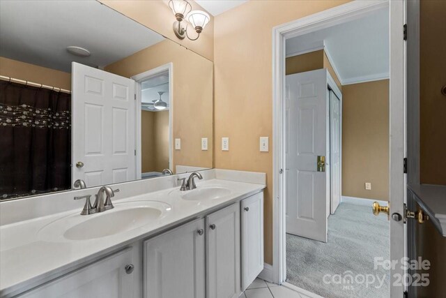 bathroom featuring double vanity and baseboards