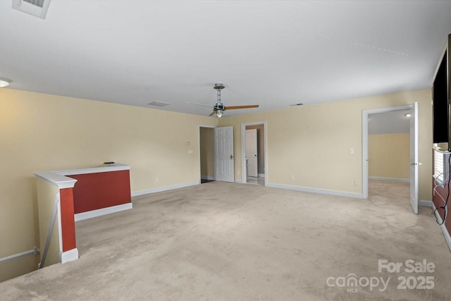 carpeted empty room with baseboards