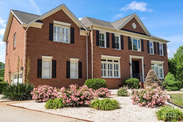 colonial-style house featuring brick siding