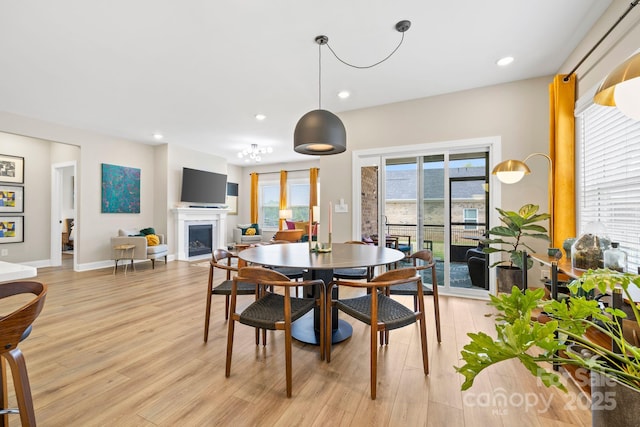 12705 Twilight Dr, Mint Hill, NC 28227 - dining room featuring a fireplace with flush hearth, baseboards, recessed lighting, and light wood-style flooring
