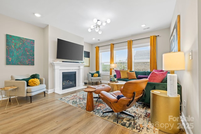12705 Twilight Dr, Mint Hill, NC 28227 - living area with recessed lighting, baseboards, a glass covered fireplace, and wood finished floors