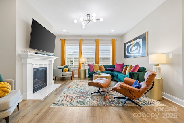 12705 Twilight Dr, Mint Hill, NC 28227 - living room featuring a notable chandelier, recessed lighting, baseboards, wood finished floors, and a high end fireplace