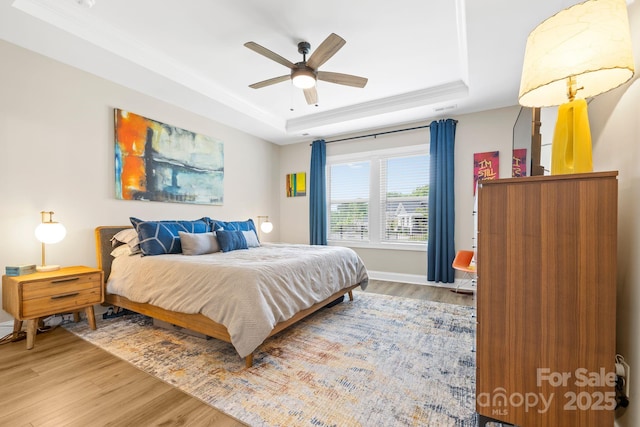 12705 Twilight Dr, Mint Hill, NC 28227 - bedroom with baseboards, ornamental molding, a raised ceiling, and wood finished floors