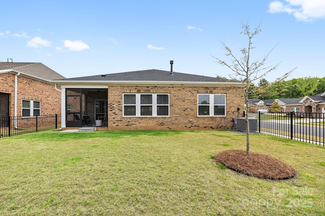12705 Twilight Dr, Mint Hill, NC 28227 - rear view of property featuring brick siding, a sunroom, a fenced backyard, central AC unit, and a lawn