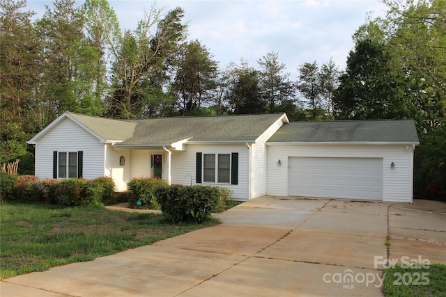 ranch-style house featuring an attached garage, a front lawn, and driveway
