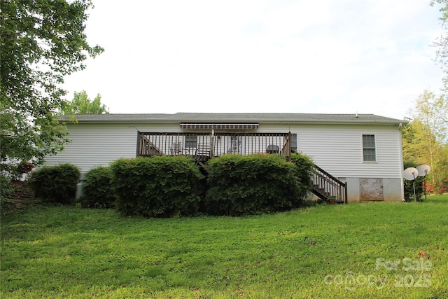 back of house featuring a yard, stairs, and a deck