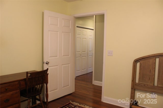 office with baseboards and dark wood-style flooring