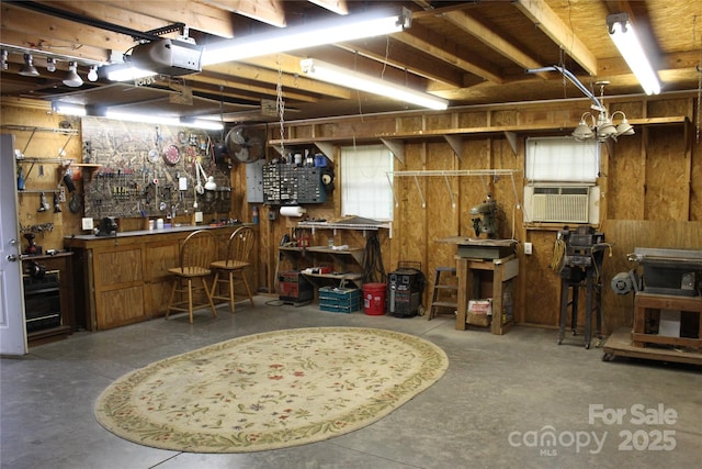 below grade area with a workshop area and wood walls