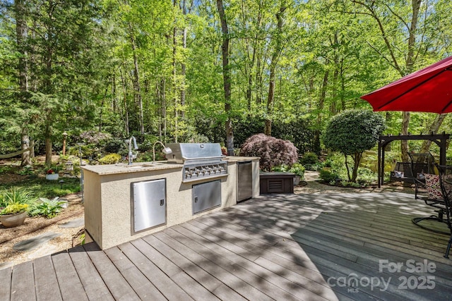 6914 Riesman Ln Unit 95, Charlotte, NC 28210 - wooden terrace featuring grilling area, an outdoor kitchen, and a sink
